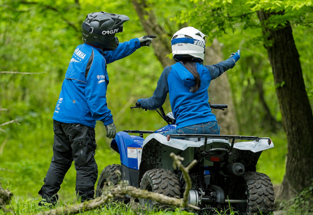 林間のオフロードコースをATV（四輪バギー）で走行する様子